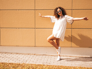 Beautiful smiling model with afro curls hairstyle dressed in summer hipster white dress.Sexy...