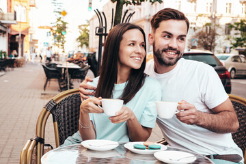 Smiling beautiful woman and her handsome boyfriend. Happy cheerful family. Couple drinking...