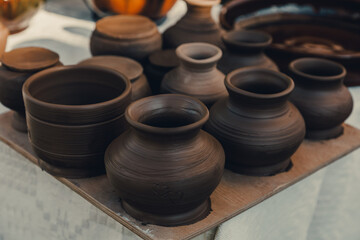 Handmade brown clay vases at workshop. Just created a pots, drying under sunlight 