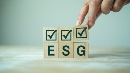 ESG Compliance Hand Placing a Check Mark on Wooden Blocks Representing Environmental, Social, and Governance Factors