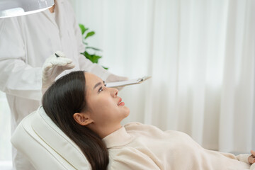 Specialist of hair recheck hair of Asian woman, damaged hair, hair loss, thinning problem, vitamin...