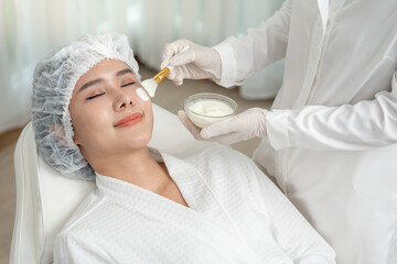 Beautiful woman receive spa and treatment skin of face. face of a healthy woman apply cream....