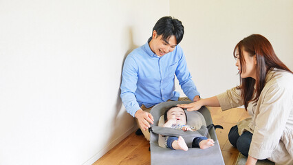 Couple soothing a baby in a room