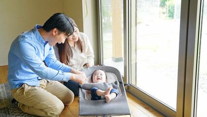 Couple soothing a baby in a room