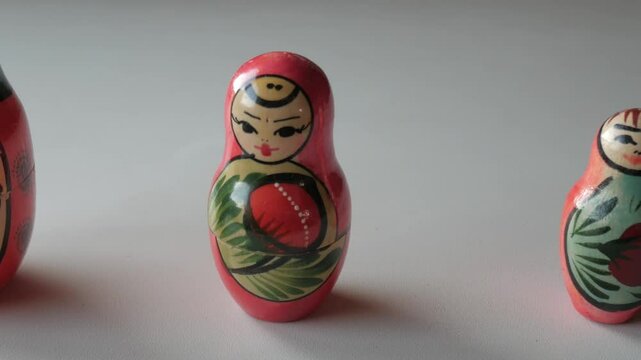 Traditional Russian Matryoshka dolls arranged in a row, focusing on details of the painted designs