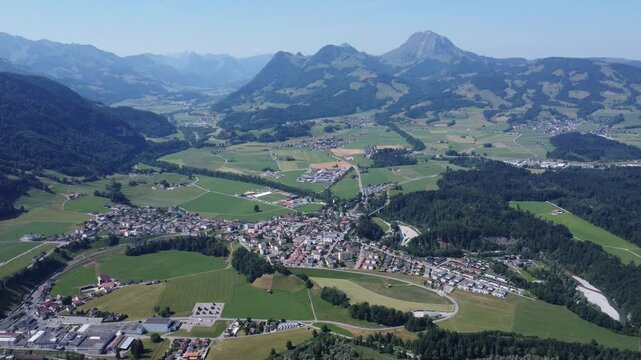 small town called broc in swizterland, green valley scenery with some mountains in the background