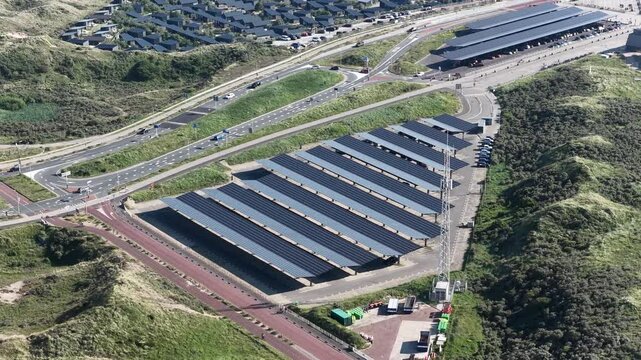 solar panels and car park, Bloemendaal, The Netherlands. Electric vehicle charging. Aerial video.
