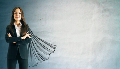 Confident businesswoman in suit with drawn superhero cape on textured wall background, symbolizing...