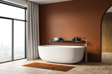 Modern minimalist bathroom with white bathtub, brown wall, and large window overlooking city view...