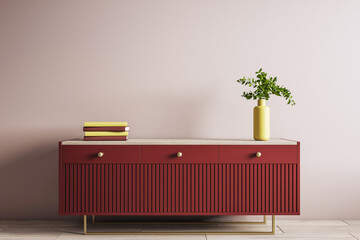 Modern red wooden sideboard with yellow vase and books against beige wall in stylish interior room...
