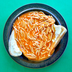  top view of tinned spaghetti on lightly toasted bread with butter.