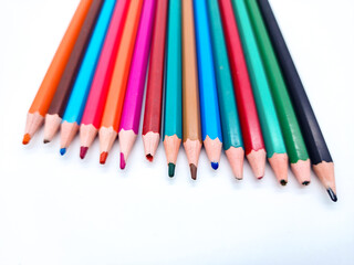 Diverse Collection of Sharpened Colored Pencils on a White Surface