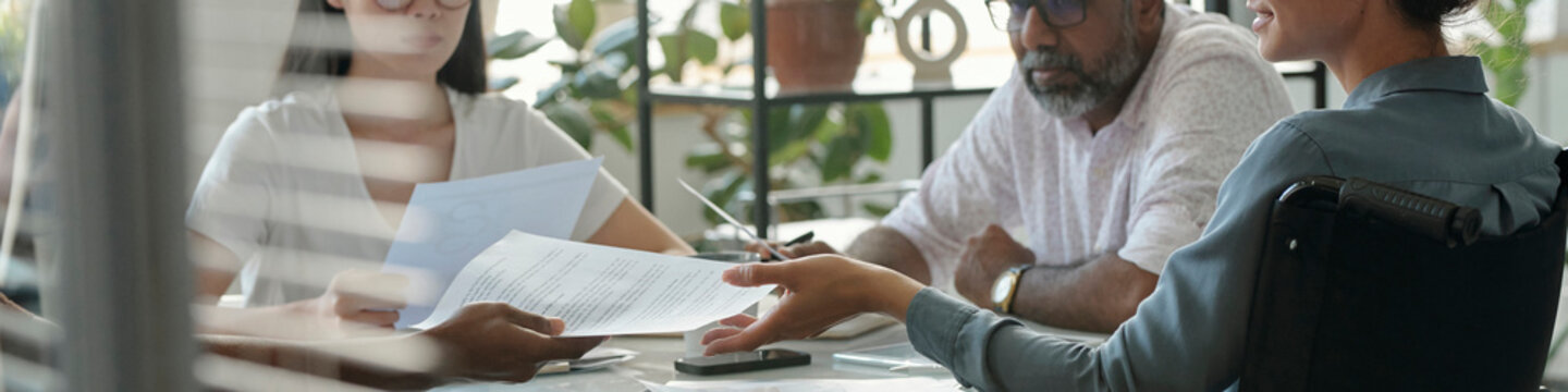 Diverse team discussing documents in an inclusive office setting