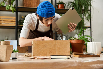Hands on gardening in a creative studio with a young man nurturing fresh plants