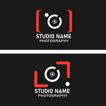 A modern photography studio logo featuring a stylized camera icon with red brackets, a white lens, and a black background. Bold text reads "Photography Studio," expressing a creative .