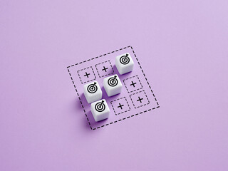 Businessman achieving business goals represented by dice and targets