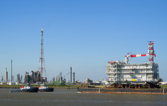 Offshore windfarm transformator station being transported by tugboats in the Netherlands