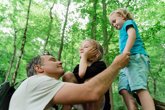 Father spending quality time with children in a forest setting