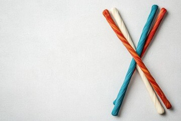 Colorful Candy Sticks: A delightful array of vibrant candy sticks in red, cream, and blue hues are neatly arranged, offering a playful and sweet visual treat.