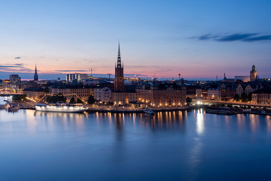 Scenic view of Stockholm's Riddarholmen and Gamla Stan at sunset with reflections on Lake Malaren.