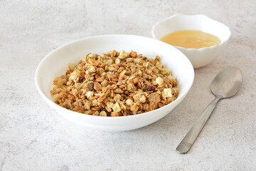 Healthy Granola Breakfast Bowl with Honey and Spoon