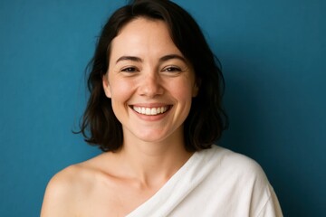 Embracing joy with a radiant smile against a calming blue backdrop