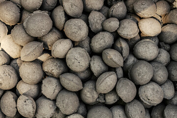Close up of charcoal briquettes on a pile.