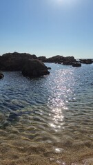 The Gondarem Beach in Foz do Douro, Porto, Portugal. Calm tide over rocky coastline and coarse sand, perfect for resting and relaxing in the summer by the Atlantic shore.