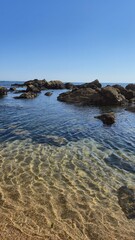 The Gondarem Beach in Foz do Douro, Porto, Portugal. Calm tide over rocky coastline and coarse sand, perfect for resting and relaxing in the summer by the Atlantic shore.