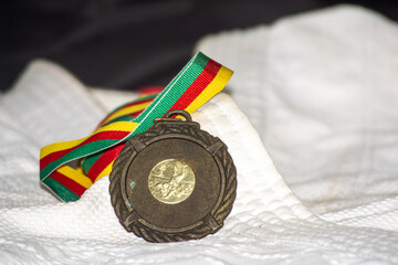 Sports medal on kimono – African victory in martial arts
