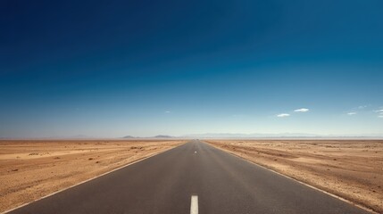 Naklejka premium Long straight desert highway in summer, heat haze and blue sky above,