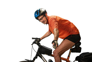 Active sporty man riding cycle with ultrasonic dog repeller. Outdoor cyclist using personal device for dog attack prevention, ensuring safety on the road.