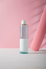 Cosmetics bottle template, unbranded, no logo. Paper roll as decorative element on pink background. Mockup Product presentation, advertising banner, copy space