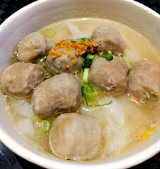 Delicious meatball soup with noodles and broth.
A culinary delight. Top view.