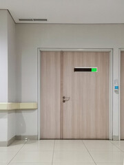 Fototapeta premium Empty hospital corridor with wooden door. Hospital doctor's room door, medical clinic entrance, modern and clean interior.