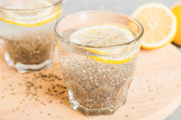 Healthy breakfast or morning with chia seeds and lemon on table background, vegetarian food, diet and health concept. Chia pudding with lemon