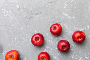 Many red apples on colored background, top view. Autumn pattern with fresh apple above view with...