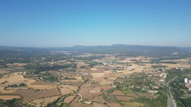 Aerial view of a landscape with mountains, fields and buildings, from El Bages, Catalonia