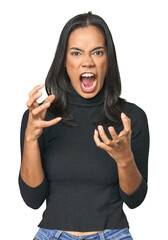 Simple portrait of a young Latina screaming with rage.