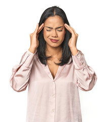 Simple portrait of a young Latina touching temples and having headache.