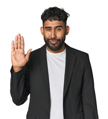 Hispanic businessman in suit in studio smiling cheerful showing number five with fingers.