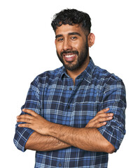 Young Hispanic man isolated who feels confident, crossing arms with determination.