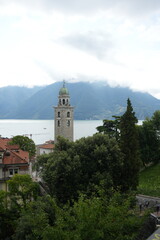 Fototapeta premium Dramatic Clouds Rolling Over Lugano with Historic Church Tower in Foreground, Ticino, Switzerland