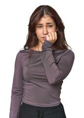 Middle Eastern woman in studio biting fingernails, nervous and very anxious.