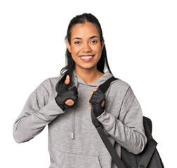 Young Filipina athlete with gym backpack smiling and raising thumb up