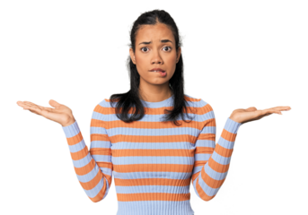 Young Filipina woman confused and doubtful shrugging shoulders to hold a copy space.