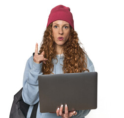 Redhead young woman student with laptop having some great idea, concept of creativity.