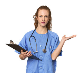 Nurse with report in studio showing a copy space on a palm and holding another hand on waist.