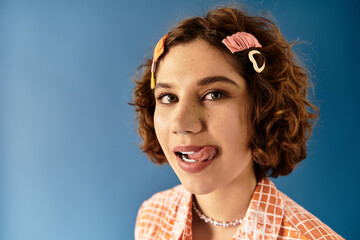 Young woman showcases vibrant summer fashion against a bright blue backdrop