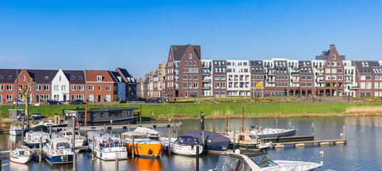 Panorama of boats in the harbor of historic city Grave, Netherlands